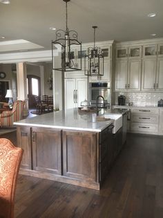 a large kitchen with an island in the middle