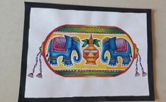 an elephant painting is hanging on the wall