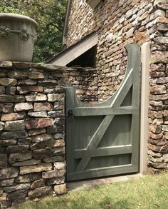 an old stone building with a wooden gate