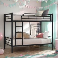 there is a bunk bed in the room with pink and blue decorations on the wall