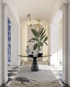 an elegant dining room with a glass table and potted plant on the rug in front of it