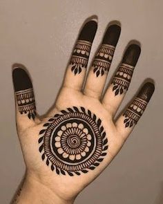 a person's hand with hennap on it and an intricate design in the middle