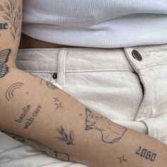 a person with tattoos on their arms and legs