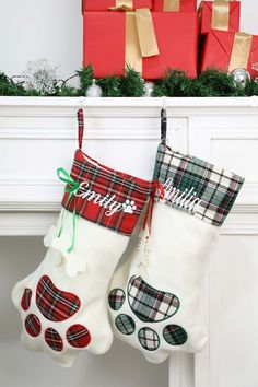 two christmas stockings hanging from a mantel