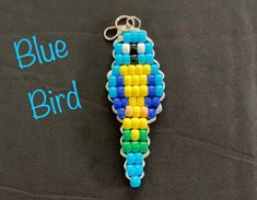 a keychain made out of legos on a black background with the words blue bird