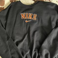 This Super Cute Nike Halloween Crewneck Sweater. Never Worn Brand New! Size Xl. Let Me Know If You Have Any Questions Black Fall Sweater For College, Orange Letter Print Sweatshirt For Winter, Brown Sweatshirt For College In Fall, Black Sporty Sweater For Fall, Fall College Brown Tops, Orange Long Sleeve Sweater For Streetwear, Orange Long Sleeve Top For College, Long Sleeve Orange Tops For College, Sweaters Nike