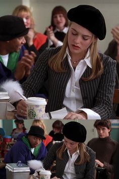 a woman sitting at a table in front of a group of people holding coffee cups