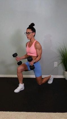 a woman doing squats with dumbbells in her hand and holding a kettle