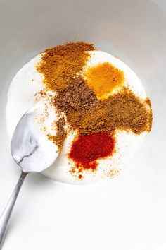 spices and seasonings in a bowl with a spoon