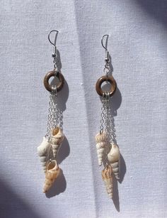 Handmade earrings made from shells, chain, and a wooden hoop. These mini wind chimes are perfect for summer or any beach day! Natural Dangle Beach Jewelry, Natural Dangle Jewelry For Beach, Natural Color Dangle Jewelry For Beach, Ocean-inspired Dangle Hoop Earrings For Beach, Dangle Earrings For The Beach, Pierced Dangle Earrings For Beach, Beach Dangle Shell Earrings With Ear Wire, Shell Dangle Hoop Earrings For Beach, Dangle Earrings For Beach