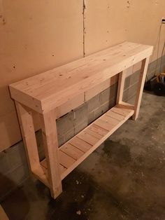 a bench made out of pallet wood in a room that is being worked on