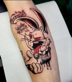 a person with a tattoo on their arm that has an image of a rabbit in it