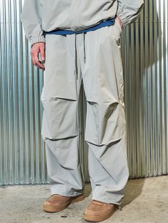 Editor's notesIt is a casual parachute pant for unisex. Made of dense heavyweight nylon spandex fabric  the pant is waterproof and has comfy fit. The pant has parachute design point on the front and double stitching for durable finish. The silhouette of the pant is adjustable using drawcords on the hem. - Elastic waist with drawstring- Side pockets- Patched back pocket- Spandex blend fabricMeasurements(in.)Size 1 / Size 2- Length: 39.8 in. / 40.9 in.- Waist: 13.8 in. / 14.2 in.- Thigh: 13 i Techwear Parachute Pants For Outdoor Activities, Techwear Baggy Parachute Pants For Outdoor, Baggy Techwear Parachute Pants For Outdoor, Urban Style Baggy Parachute Pants For Outdoor, Urban Parachute Pants For Outdoor, Relaxed Fit Parachute Pants For Outdoor, Functional Khaki Parachute Pants For Outdoor Activities, Nylon Parachute Pants For Streetwear Techwear Style, Nylon Techwear Parachute Pants For Streetwear