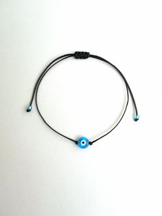 Kabbalah red string light blue evil eye bracelet.Wear it like Madonna! This simple yet beautiful bracelet is made using durable red waxed string and has a glass beed evil eye charm in the middle,and light blue glass seed beads at the ends. The diameter of the flat eye bead is 7mm approx. It is adjustable with a sliding knot closure. Similar bracelets: https://www.etsy.com/listing/219992721/blue-evil-eye-in-red-stringsimple?ref=pr_shop , https://www.etsy.com/listing/222844772/blue-evil-eyesimple- Adjustable Turquoise Evil Eye Bracelet, Adjustable Blue Evil Eye Bracelet With Sliding Knot, Turquoise Evil Eye Bracelet As Gift, Blue Evil Eye Bracelet With Sliding Knot For Gift, Blue Evil Eye Bracelet With Sliding Knot As Gift, Spiritual Evil Eye Bracelet With Adjustable Cord As Gift, Spiritual Evil Eye Bracelet With Adjustable Cord, Red String Lights, Light Blue Evil Eye