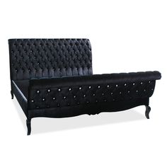 a black velvet bed frame with studded buttons