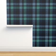 a black and green plaid wallpaper in an empty room