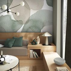 a living room filled with furniture and a painting on the wall above it's headboard