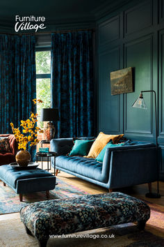 a living room with blue walls and furniture in front of a window that reads furniture village