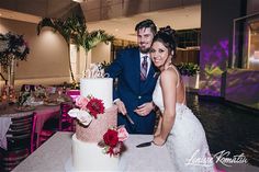 a newly married couple cutting their wedding cake