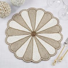 a place mat on a table with wine glasses and utensils