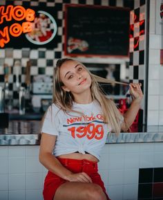 a woman sitting in front of a diner counter