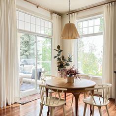 a dining room table with four chairs around it