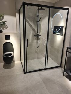 a bathroom with a toilet, shower and stand - up shower in the middle of it