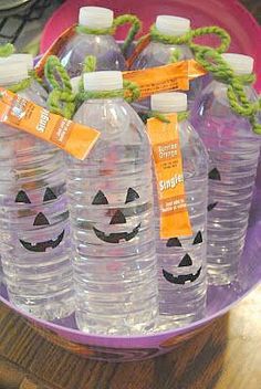 plastic water bottles with pumpkin faces on them