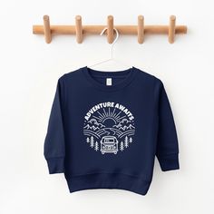 Looking for a cute sweatshirt for your kids? We have the perfect Adventure Awaits Landscape Circle With Van graphic sweatshirt addition to their closet! Also available in youth sweatshirts. Camp Sweatshirt, Vans Toddler, Cute Sweatshirts, Top Graphic Tees, Toddler Girl Outfits, Adventure Awaits, Tee Shop, Toddler Outfits, Sleeve Styles