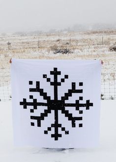 a white banner with black squares on it in the snow