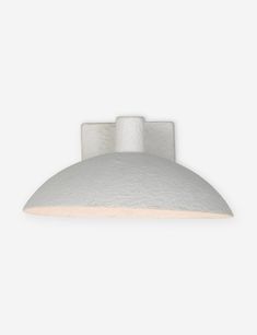 a white light fixture on a wall