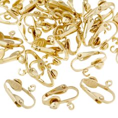 a pile of gold colored metal objects on a white background