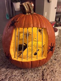 a pumpkin shaped like a jail cell with spider webs on it