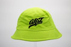 Griz Bucket Hat is the perfect addition to any festival or rave outfit. Made to be both stylish and functional, this bucket hat is a must-have clothes accessory for any fashion-forward individual.  Crafted with high-quality materials, this bucket hat guarantees long-lasting use while keeping your head cool and comfortable. Its sleek design allows you to pair it with a variety of outfits, making it a versatile piece in your fashion accessories collection. Whether you're out in the sun or dancing all night long, Griz Bucket Hat has got you covered - literally! Don't miss out on this trendy rave accessory! Cheap Multicolor Festival Bucket Hat, Adjustable Green Bucket Hat For Festivals, Green Short Brim Bucket Hat For Streetwear, Green Bucket Hat For Festivals, Green Bucket Hat For Streetwear, Adjustable Hip Hop Bucket Hat, Adjustable Green Bucket Hat For Streetwear, Green Bucket Hat For Summer Streetwear, Green Festival Bucket Hat With Curved Brim