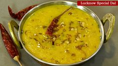 a metal bowl filled with yellow colored food