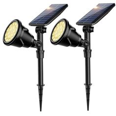 two solar powered spotlights on top of each other