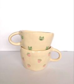 two ceramic cups sitting side by side on a table