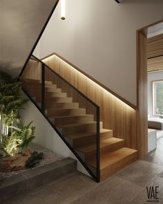 the stairs in this modern house are made from wood and metal, with lighting above them