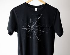 a black t - shirt with an image of a star in the sky on it