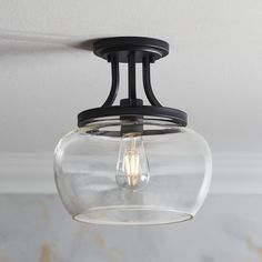 a glass light fixture hanging from the ceiling