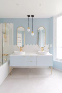 a bathroom with two sinks, mirrors and a bathtub in the middle of it