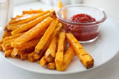 french fries and ketchup on a white plate