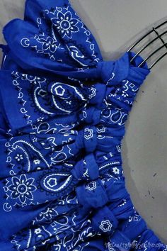 a blue bandana is hanging on a metal rack