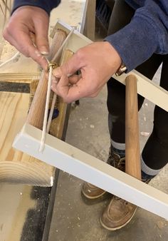 a person working with wood on a piece of furniture