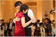 a man and woman dance together at a wedding reception