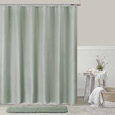 a bathroom with a shower curtain and rug