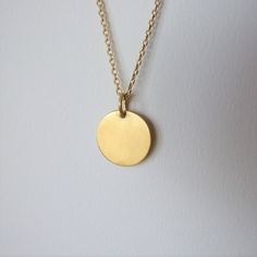 "This minimalistic 14k gold pendant is unisex and a perfect gift for a man. It is made of 14k gold and has an elegant matte finish. The pendant can be ordered by itself or with a chain necklace. You can choose the color of 14k gold of the pendant and the chain necklace will be made of- yellow or white gold. I plate the white gold with rhodium as common in white gold jewelry The diameter of the round pendant is 0.62 inches ( 1.6 cm ).  If you decide to order the pendant with the chain necklace yo Yellow Gold Charm Necklace With Round Pendant, Gold Necklace With Simple Round Design, Simple Gold Necklace With Round Pendant, Simple Gold Round Necklace, Simple Gold Necklace With Round Shape, Yellow Gold Necklace With Simple Round Pendant, Modern Yellow Gold Round Disc Jewelry, Minimalist Engraved Circular Jewelry, Minimalist Engraved Circle Jewelry