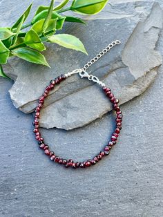 Adorn your wrist with this stunning dainty bracelet! It boasts rich red garnet nuggets complemented by sterling silver accents. Fastening with a sterling silver lobster clasp and components, it is perfect for wearing alone or layering with your favorite pieces. BRACELET FEATURES:  * Bracelet extends from 6 1/2" - 8" (7" is the average size of a woman's wrist) * 4mm Garnet Gemstones  * Sterling Silver Accents & Lobster Claw Clasp * 1.5" Sterling Silver Extender Chain ♥  Sterling silver is hypoallergenic and safe to wear for those with sensitive skin. ♥  All orders come beautifully hand-packaged with care, making it the perfect gift for yourself or someone special.  ♥  Each piece is handmade with love in my home studio in Rockaway, NJ. Red Garnet Crystal Bracelet, Luxury Garnet Bracelets For Gift, Devil Costume, Bracelet Stacking, Bracelet Minimalist, Garnet Bracelet, Minimalist Bracelet, Dainty Bracelets, Garnet Gemstone