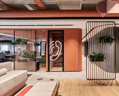 an office with wooden floors and orange walls