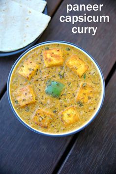 paneer capsicum curry in a bowl on a wooden table with pita bread